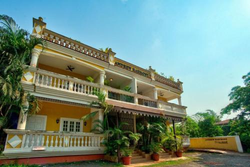 a large yellow building with plants in front of it at Coastal Bliss By Masaka in Anjuna