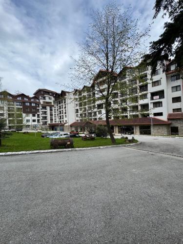 an empty street in front of a large apartment building at Borovets Gardens MVS Apart D42 in Borovets