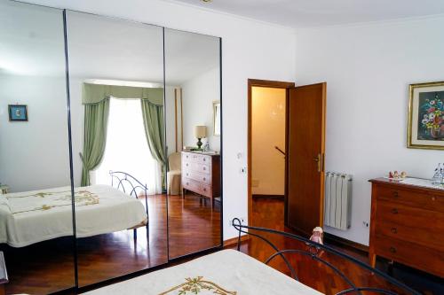 a bedroom with a mirror and a bed and a dresser at A casa di Dany in Palidoro