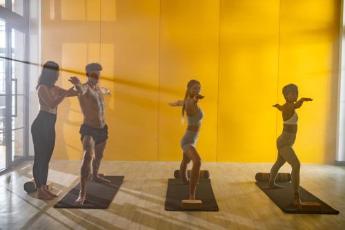 a group of man and woman statues in a room at Elite Atoll Serviced Apartments Phuket in Rawai Beach