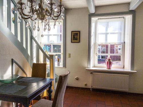a dining room with a table and a window at Ferienwohnung Siel 40 Ditzum 45253 in Ditzum