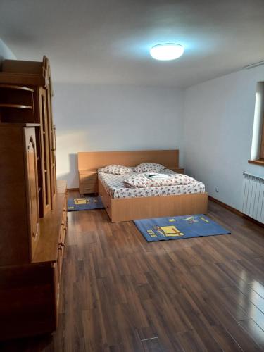 a bedroom with a bed and a dresser in it at Vila Verde in Mangalia