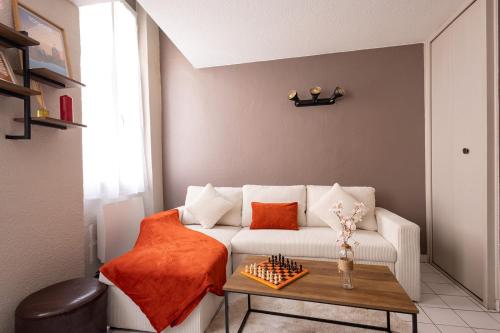 un salon avec un canapé blanc et une table dans l'établissement Cosy Home - Loft in City Center Toulouse - Charman Duplex au coeur de Toulouse, à Toulouse