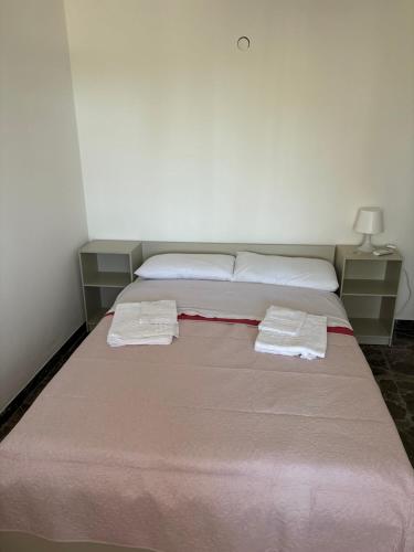 a bed in a room with two towels on it at Casa Felice in Senigallia