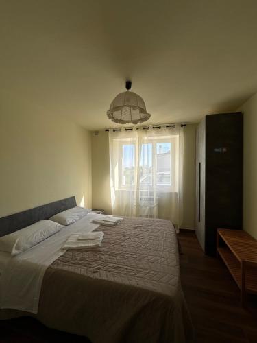 a bedroom with a large bed and a window at Casa Felice in Senigallia