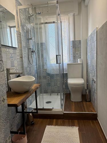 a bathroom with a shower and a sink and a toilet at Casa Felice in Senigallia