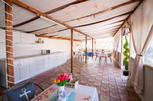 a kitchen and dining room with a table and chairs at Casa Irina 2Mai in 2 Mai