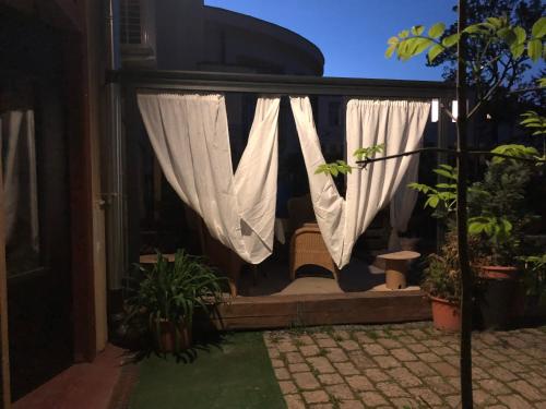 a window with curtains and plants in a yard at Apartmány na Náměstí in Český Brod