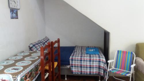 a room with a table and two chairs and a bed at Apto Temporada na Ilha de Paquetá in Paquetá