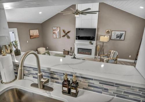 a kitchen with a sink and a living room at Swim and Relax In our Pool and Hot Tub and Recently Renovated in Ashtabula