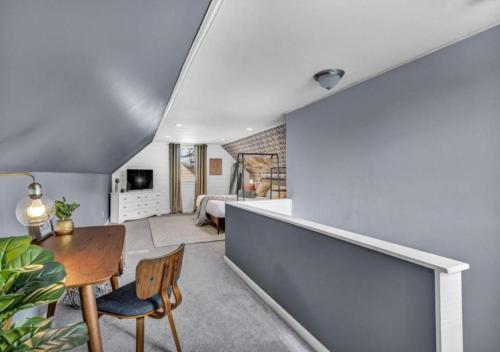 a living room with a table and a bedroom at Swim and Relax In our Pool and Hot Tub and Recently Renovated in Ashtabula