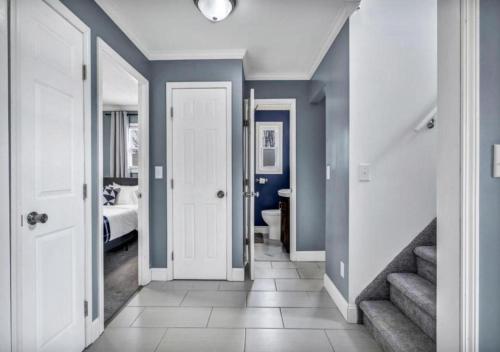 a hallway with a room with a bed and a staircase at Swim and Relax In our Pool and Hot Tub and Recently Renovated in Ashtabula