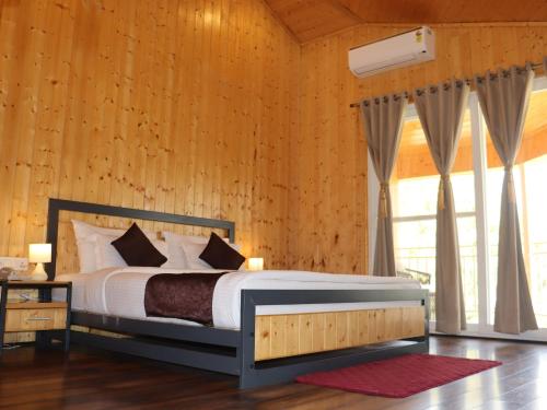 a bedroom with a bed and a large window at The Woods Retreat in Lansdowne