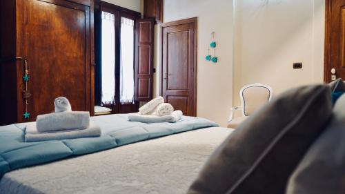 a bedroom with two towels on top of a bed at Antica Dimora San Girolamo in Licata