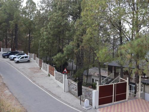 a street with cars parked on the side of a road at The Woods Retreat in Lansdowne