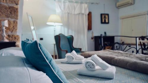 a hotel room with two beds with towels on them at Antica Dimora San Girolamo in Licata