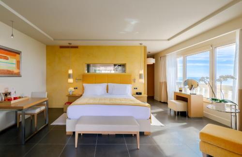 a hotel room with a bed and a desk at Monte-Carlo Bay Hotel & Resort in Monte Carlo
