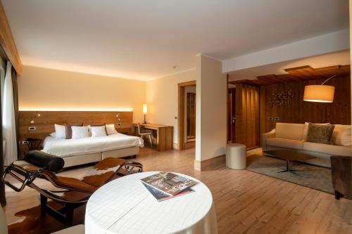 a large hotel room with a bed and a couch at Palace Hotel Wellness & Beauty in Bormio