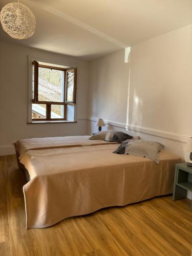 a large bed in a bedroom with a window at Odcvl - Le Moulin Gentrey in Harsault