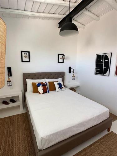 a bedroom with a large white bed with pillows at Casa da Oliveira in Reguengos de Monsaraz