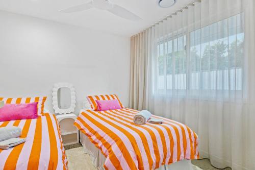 a bedroom with two beds and a window at Solis House in Tweed Heads
