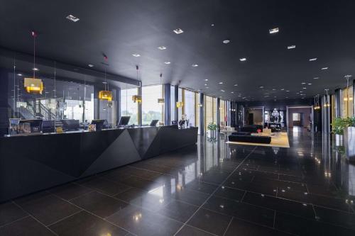 a lobby of an office with a reception desk at NH Milano Fiera in Rho