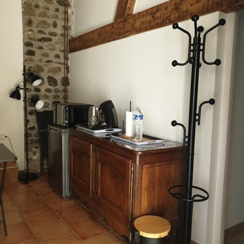 - une cuisine avec un comptoir en bois, un four micro-ondes et une table dans l'établissement Logement indépendant chez l'habitant, situé dans les Pyrénées, à Bordères-sur-lʼÉchez