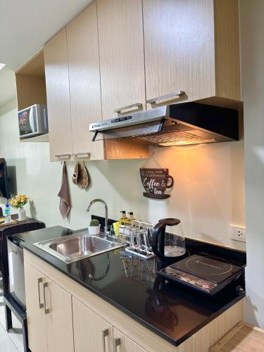 a kitchen with a sink and a counter top at Cordillera Breeze Suites Baguio Transient at Brenthill Condo in Baguio