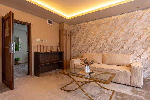 a living room with a couch and a table at PENSIUNEA GAMBRINUS **** in Miercurea-Ciuc