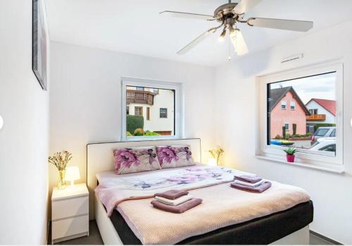 a bedroom with a bed with two towels on it at Ruhige Wohnung mit Terrasse in Oberbrechen