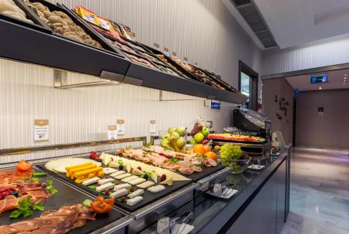 a large selection of fresh produce is displayed in a store at Ikonik Ramblas in Barcelona