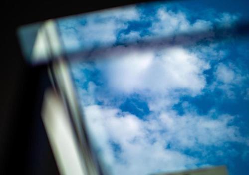 a mirror view of a blue sky with clouds at Hot Tub N64 Mins to Downtown Sleeps 8 in Cleveland