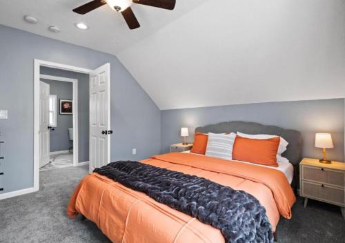 a bedroom with a large bed and a ceiling fan at Hot Tub N64 Mins to Downtown Sleeps 8 in Cleveland