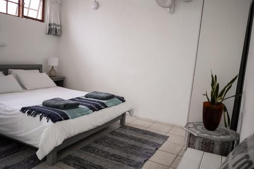a bedroom with a bed with two pillows on it at Moonstone Lodge in Ponta do Ouro