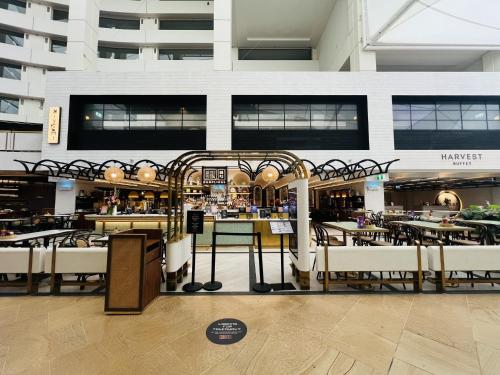 a restaurant with tables and chairs in a building at La Jolla Holiday Broadbeach in Gold Coast
