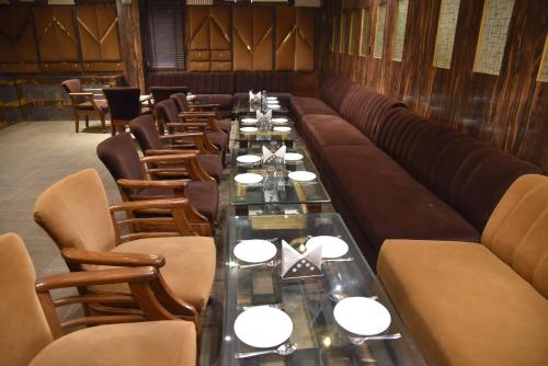 a long dining room with a long table and chairs at Sky Star Hotel in Amritsar