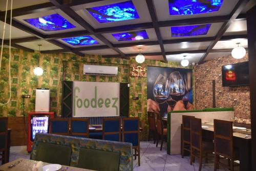 a restaurant with stained glass ceilings and tables and chairs at Sky Star Hotel in Amritsar