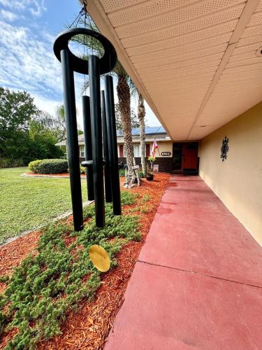 a sidewalk with two black poles next to a building at Paradise at Peaceful in Palm BayTiki Bar Pool Spa 4 Bedroom 2 Full Bathrooms 2 half Bathrooms in Palm Bay