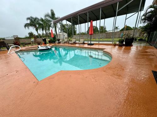 a swimming pool with water in the middle at Paradise at Peaceful in Palm BayTiki Bar Pool Spa 4 Bedroom 2 Full Bathrooms 2 half Bathrooms in Palm Bay