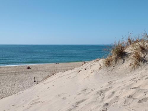 a sandy beach with the ocean in the background at Villa Marie in Courçon