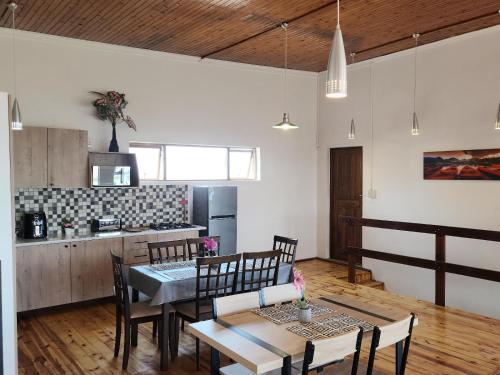 a kitchen and dining room with a table and chairs at Seaview Sunsets in Gqeberha