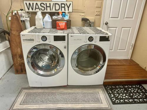 a washer and dryer sitting in a laundry room at Paradise at Peaceful in Palm BayTiki Bar Pool Spa 4 Bedroom 2 Full Bathrooms 2 half Bathrooms in Palm Bay