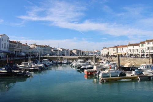 a group of boats are docked in a harbor at Villa Marie in Courçon