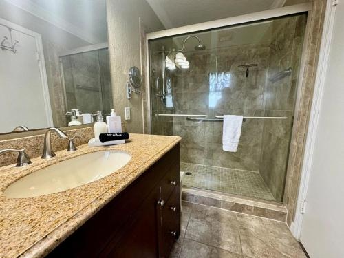 a bathroom with a sink and a shower at Paradise at Peaceful in Palm BayTiki Bar Pool Spa 4 Bedroom 2 Full Bathrooms 2 half Bathrooms in Palm Bay