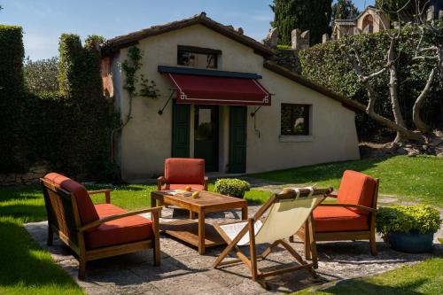 a group of chairs and a table in front of a house at Locanda San Vigilio in Garda