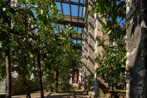 a building with trees in front of it at Locanda San Vigilio in Garda