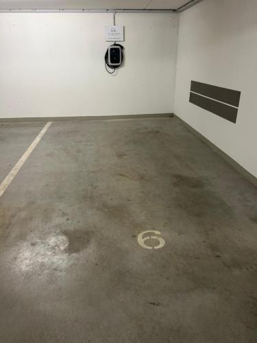 an empty parking garage with a parking sign on the ground at LUX PENTHOUSE Klopeiner See Apartment Ferienwohnung FeWo in Sankt Kanzian