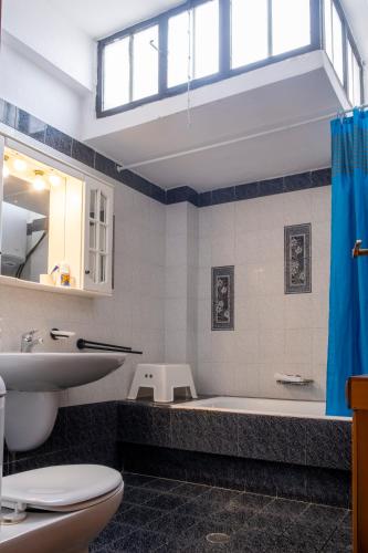 a bathroom with a tub and a sink and a toilet at Seaside Resort in Kritharia