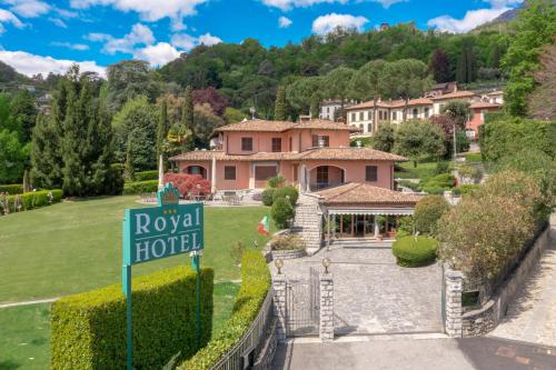 a house with a road hotel sign in front of it at Hotel Royal in Menaggio
