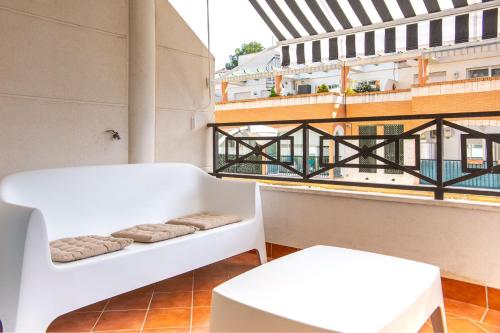 a room with two white tables and a balcony at Calpe Bay in Calpe